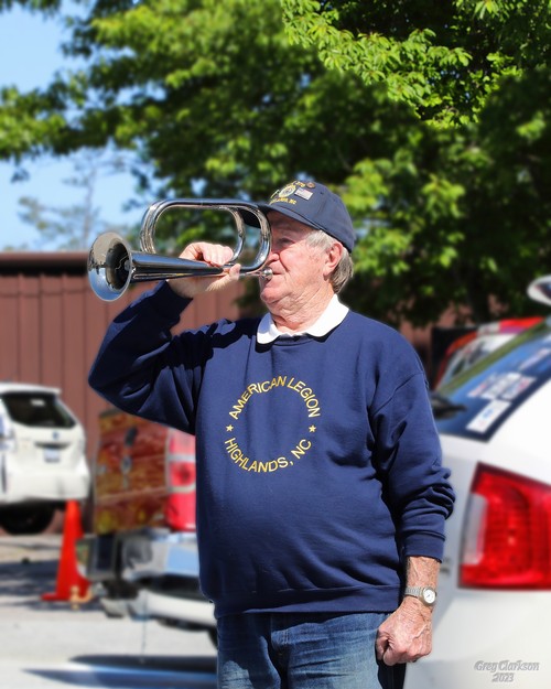 Highlands American Legion Post 370 member Ed Jones plays Taps.